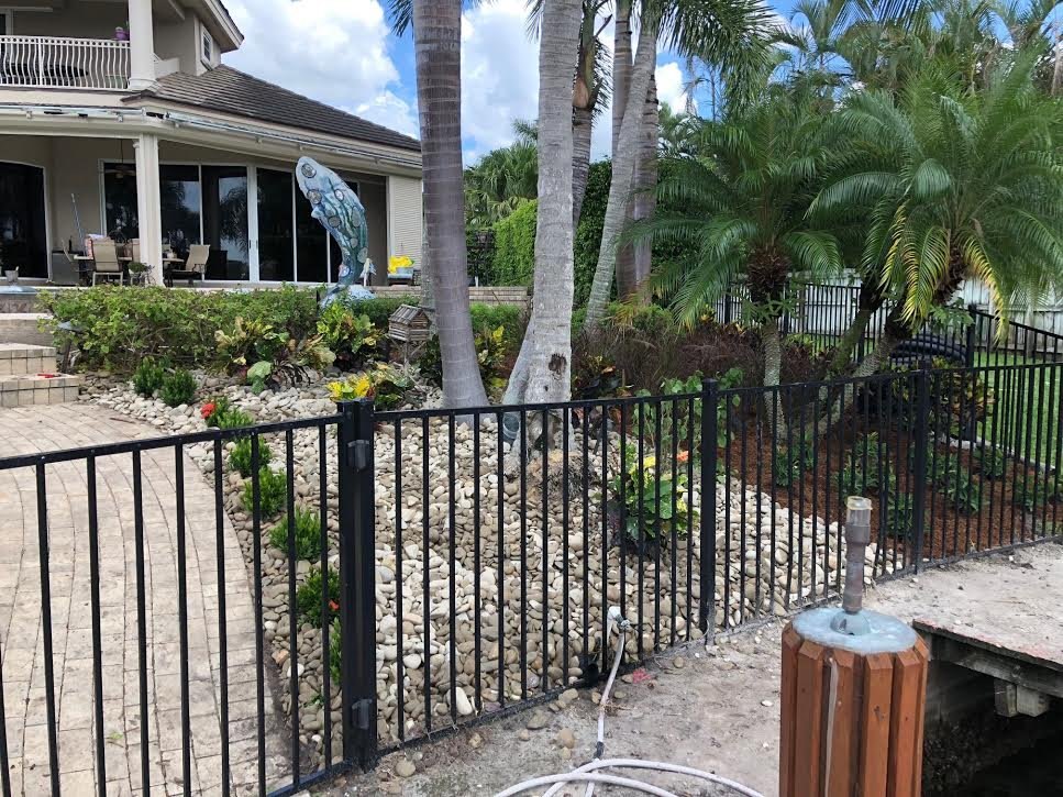 After: the same slope cleaned up and replanted with rock and fresh plantings along the walkway